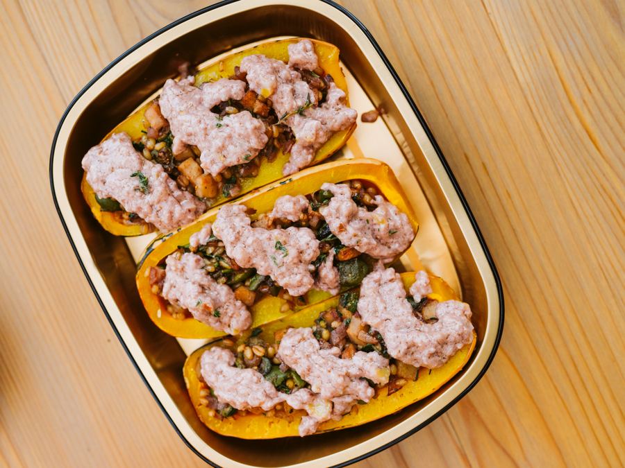 Halved delicata squash filled with wheat berries and figs