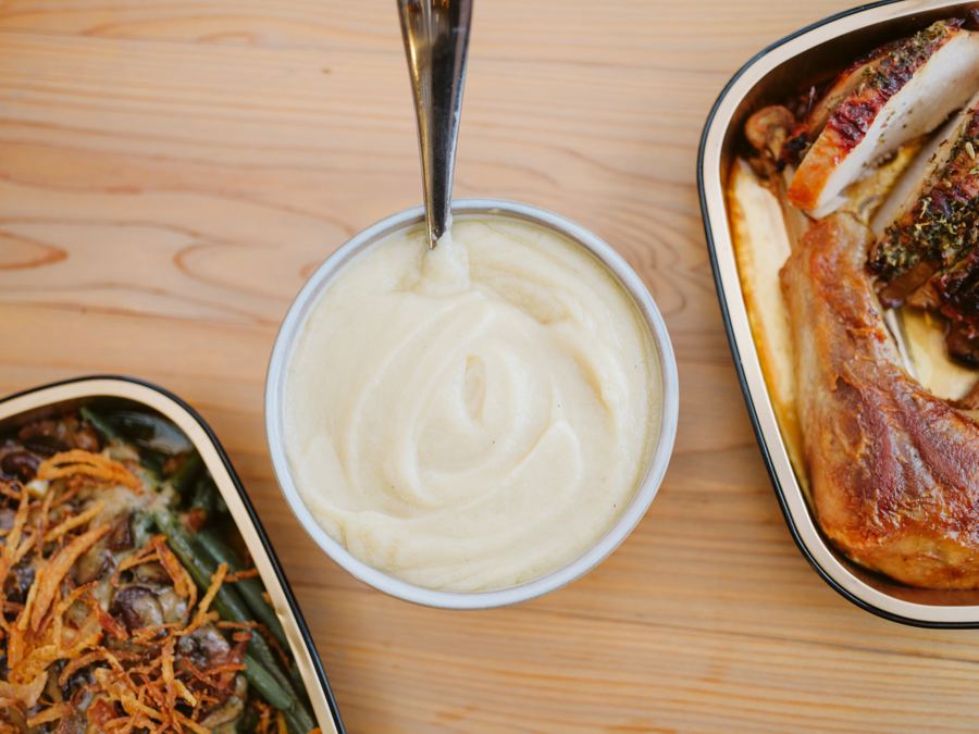 A bowl of gravy beside the turkey